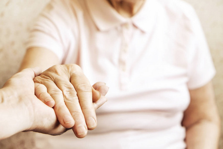  care giver, hands close up. Grand mother everyday life. Backgro