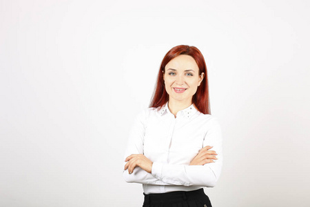  white blouse standing with arms folded on chest. Attractive wom