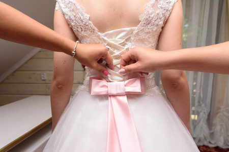s wedding dress. Pink ribbon bow on the back of wedding dress. B