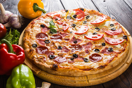 s pizza on a dark wooden background