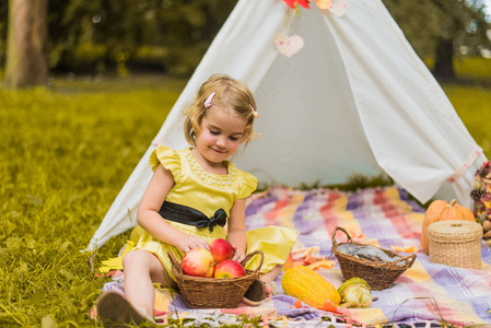 s house wigwam in park Autumn portrait of cute curly girl. Harve