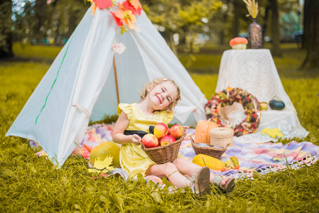 s house wigwam in park Autumn portrait of cute curly girl. Harve