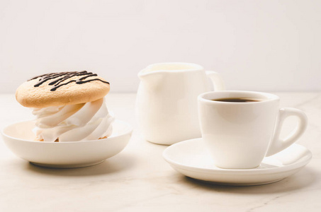 咖啡白色杯子，甜点和牛奶在白色大理石背景咖啡白色杯子与甜点和牛奶在白色大理石背景。 选择性病灶