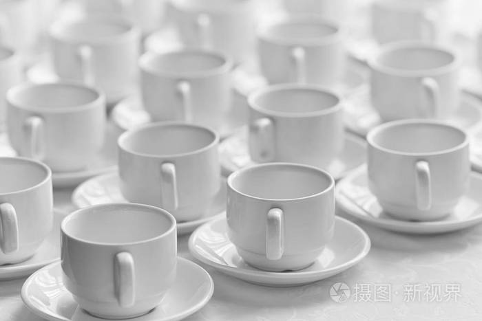 顶部的视图,许多堆放在一排排空的干净的白色杯子茶或咖啡. 快关门.