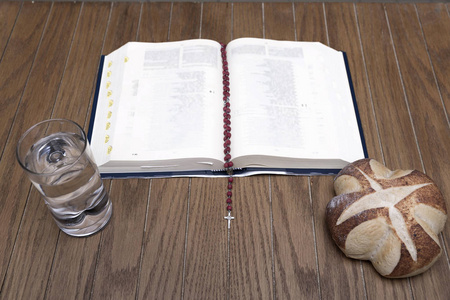 在黑暗的房间里的木桌上，借出圣经面包和水的符号