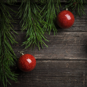 圣诞背景。 杉树枝红色圣诞球装饰在木桌上。 平面布局空间的文本。