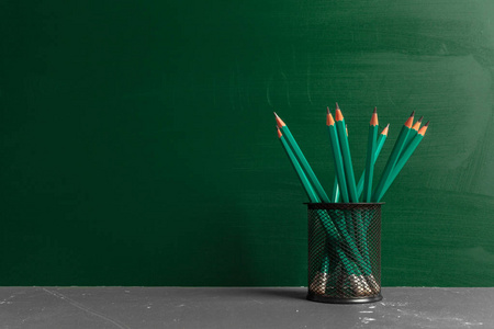 桌子上一个支架上的绿色铅笔