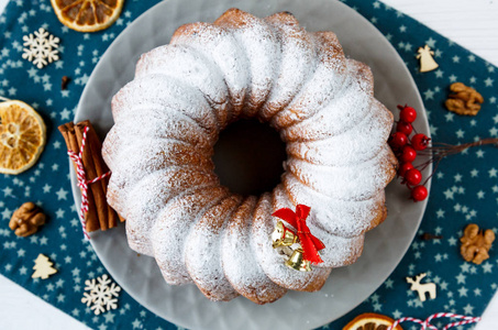 传统的圣诞水果蛋糕，装饰着粉状糖和新鲜浆果的顶部景观。 熟食自制糕点。 新年和圣诞节庆祝概念
