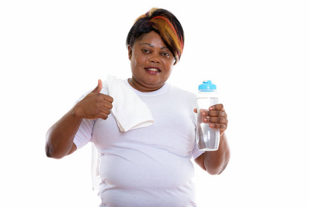 微笑着拿着矿泉水瓶的快乐胖黑色非洲女人
