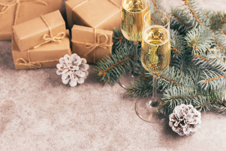 工艺礼品盒，酒杯和圣诞装饰圣诞树树枝和锥上的石板大理石背景。横向观察。复制空间。