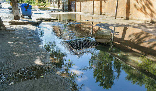 大雨期间的水流和街道污水的堵塞。 暴风雨下水道中强烈飓风期间的水流。 污水雨水系统沿道路排入排水系统