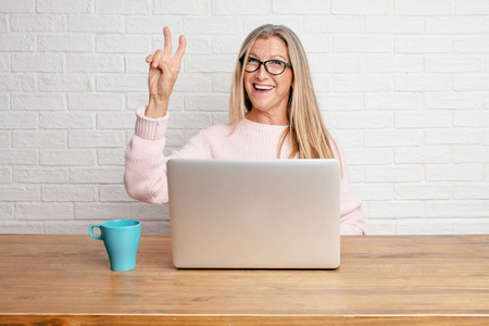  smiling and showing off success while gesturing victory, giving