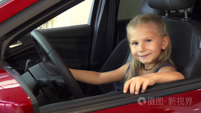 小女孩坐在方向盘上假装开车照片-正版商用图片13k2f2
