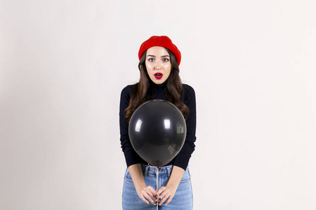  red beret, holding blank helium balloon. Holiday celebration co
