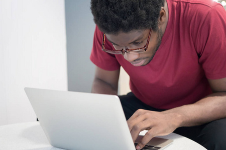  portrait of serious nerd male student studying hard in college 