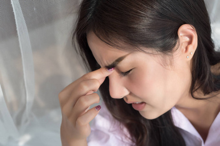  depressed woman suffers from vertigo, dizziness, migraine, hang