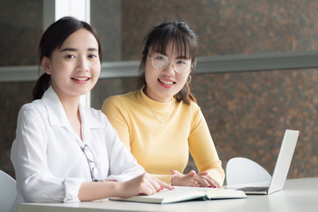  portrait of happy smiling woman students studying in college le