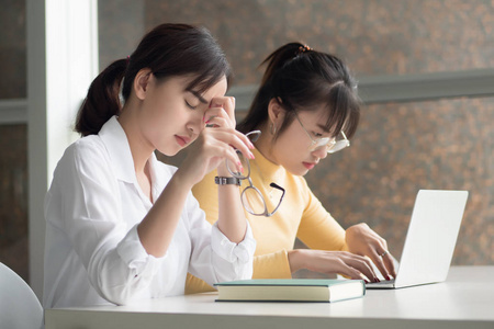  portrait of exhausted woman students studying hard in college l