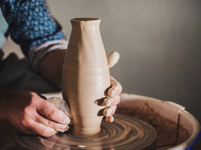 s hands creating beautiful clay product  vase  using professio