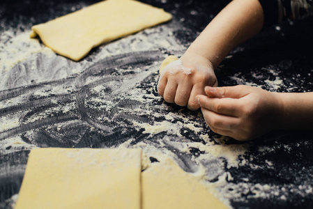 s hands learn to make dessert, playing with flour.