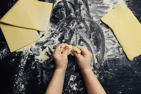 s hands learn to make dessert, playing with flour.