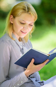 最好的自助书籍的妇女。每个女孩都应该读书。女孩感兴趣坐公园读书自然背景。阅读鼓舞人心的书籍。女性文学。放松休闲爱好概念