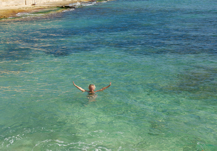 白种人白色的女人在水晶翡翠海里游泳。 暑假假期