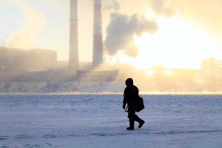 s passion, fishermen catch fish on a frozen river against the ba