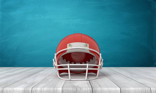 3d 渲染一个美国足球头盔躺在木制的桌子背景上, 有一堵蓝色的墙