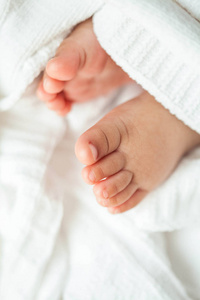 s feet in the mother hands. Baby. Cozy. Family.