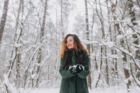 穿着绿色外套的女孩在雪地里