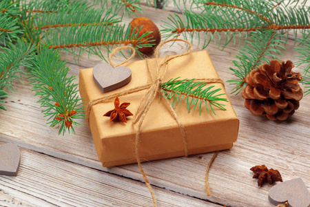 木制背景的圣诞装饰礼品盒和松树枝