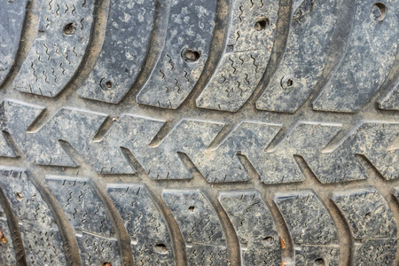 关闭用过的轮胎前部，露出保护器。 螺纹深度磨损的二手车轮胎。