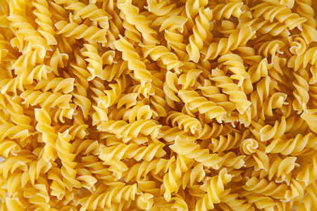 自然农业Fusilli。 面食包装的概念。 包装和3D用Fusilli的纹理。 宏观纹理。 背景图像。