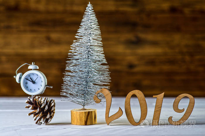 s composition: a clock and a christmas tree on a wooden backgrou