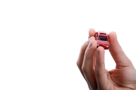 s hand holding a red car on a white background