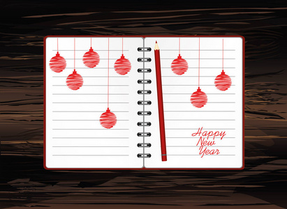 现实打开的笔记本模板与圣诞红球和铅笔。在木头上。商业日记。假日贺卡。一个现实的记事本。办公室文具。附注
