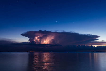 热带蓝色海面上美丽的灯光风暴日落在暴雨中长时间暴露