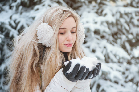 美丽的微笑的女人在户外玩雪的乐趣。 生活方式。 寒假。