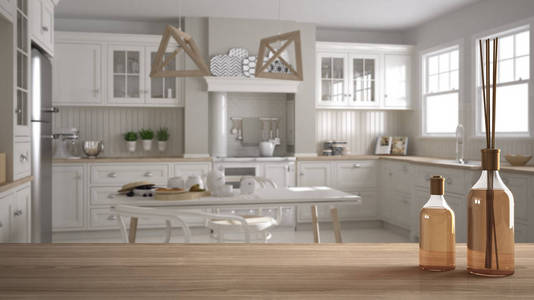 木制桌面或架子，带有芳香棒，瓶子覆盖模糊的斯堪的纳维亚经典厨房，带有餐桌和椅子，晨光白色建筑，室内设计