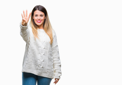 年轻漂亮的女人休闲白色毛衣，在孤立的背景上显示和指着第四个手指，同时微笑自信和快乐。