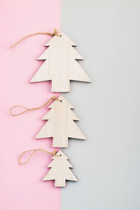 s Day festive decoration, wooden Christmas trees on pink and gra