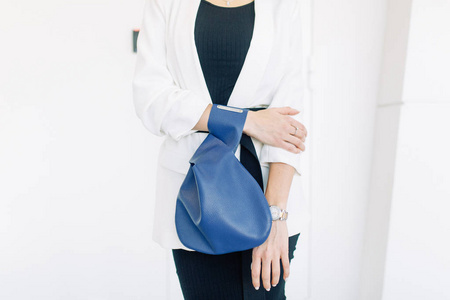 s leather bag in the hands of a stylish girl. Weblog survey for 