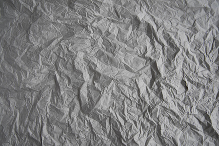 灰色皱褶包装纸背景纹理灰色褶皱的旧纸折痕在灰纸表面。