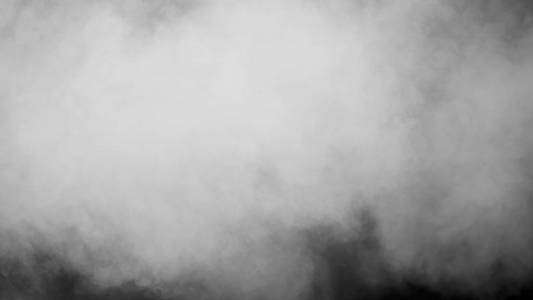 白云的蒸汽烟雾是孤立在黑色的背景上。 气体爆炸漩涡并在空间中跳舞。 一种神奇的雾尘纹理效果，可用于覆盖和改变它们的透明度。