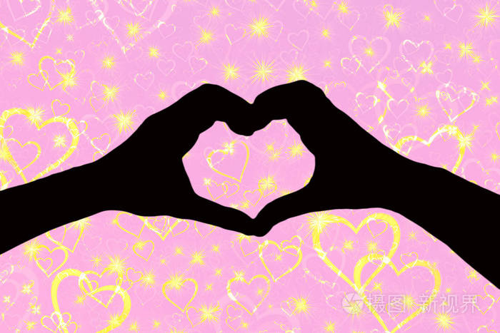 情人节背景,两只手的剪影构成了一个心形,与金色的心隔开了一个粉红色