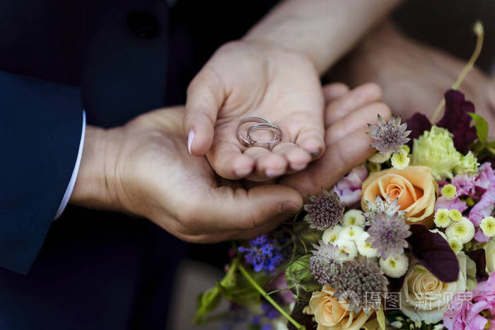 婚姻 新娘和新郎带着结婚戒指的手 手拉手 爱的触动 结婚戒指.