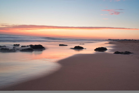 美丽的平静日出度假风景温暖的颜色岩石在海岸海岸