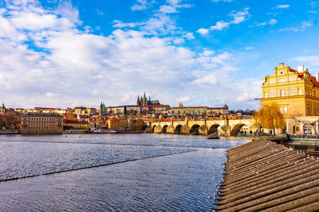 布拉格捷克共和国远望查尔斯桥和布拉格城堡。 伏塔瓦河附近阳光明媚的冬日。 布拉格城市景观与布拉格城堡的全景。 捷克首都。