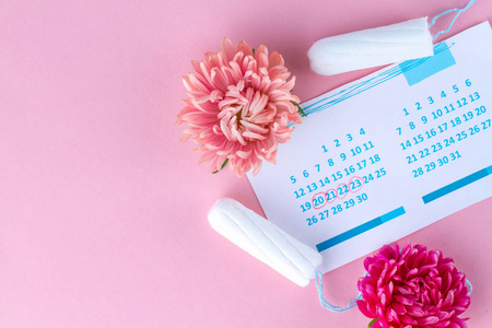 s calendar and flowers on a pink background. Hygiene care during